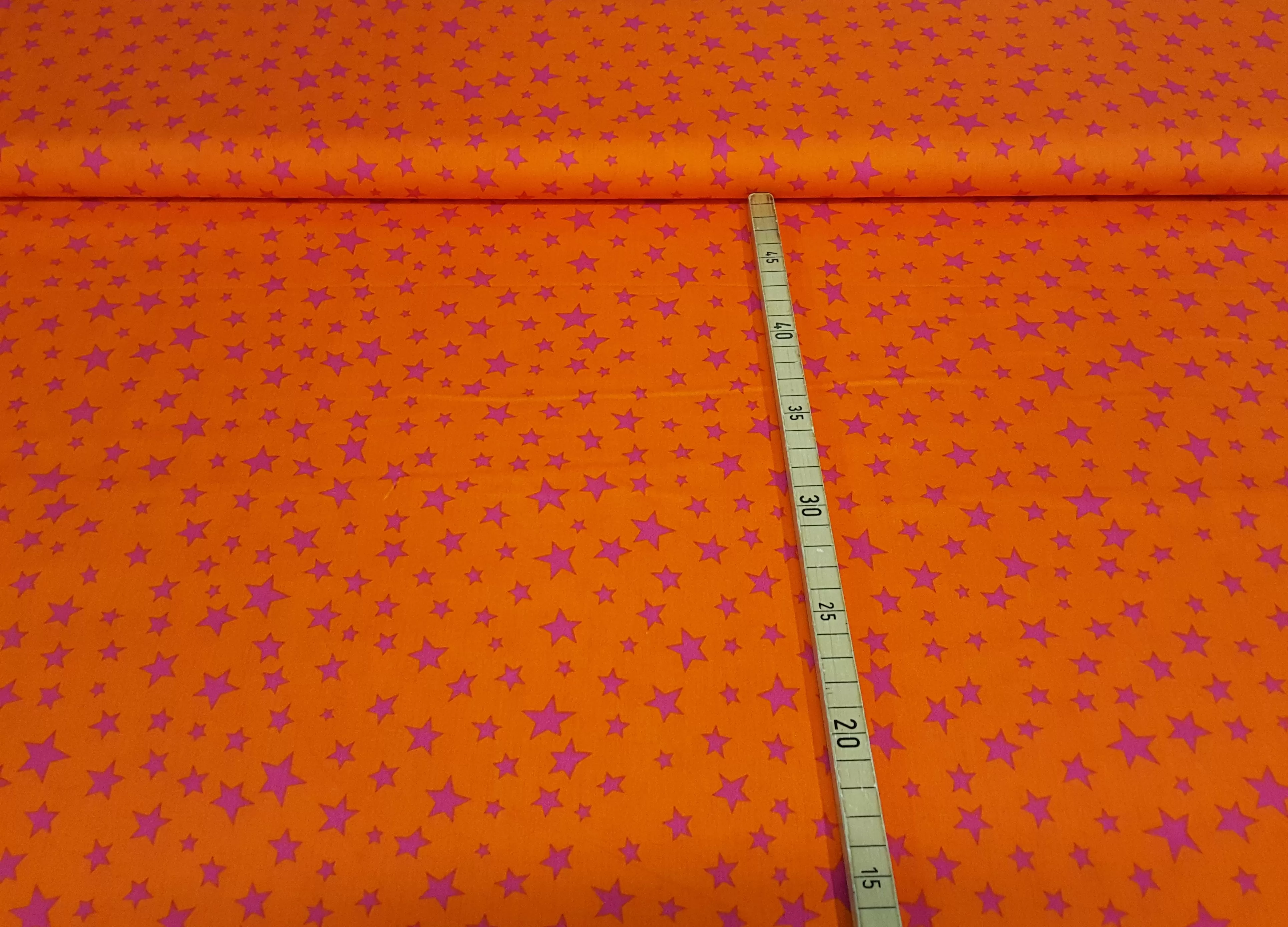 Baumwollstoff Webware in orange mit fuchsia farbenen Sternen