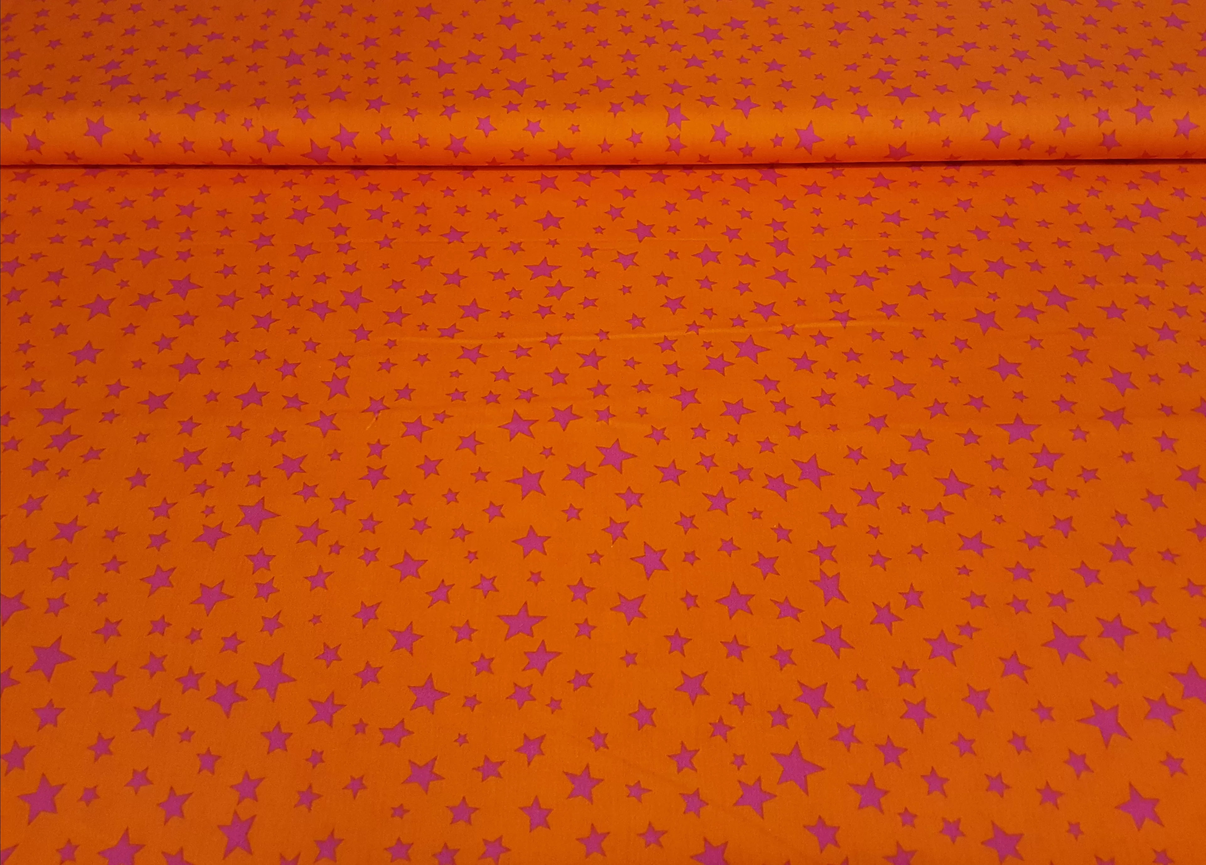 Baumwollstoff Webware in orange mit fuchsia farbenen Sternen